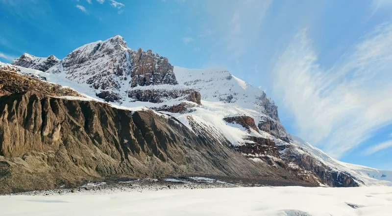 Snow-covered peaks above the Columbia Icefield with the glacier surface stretching below
